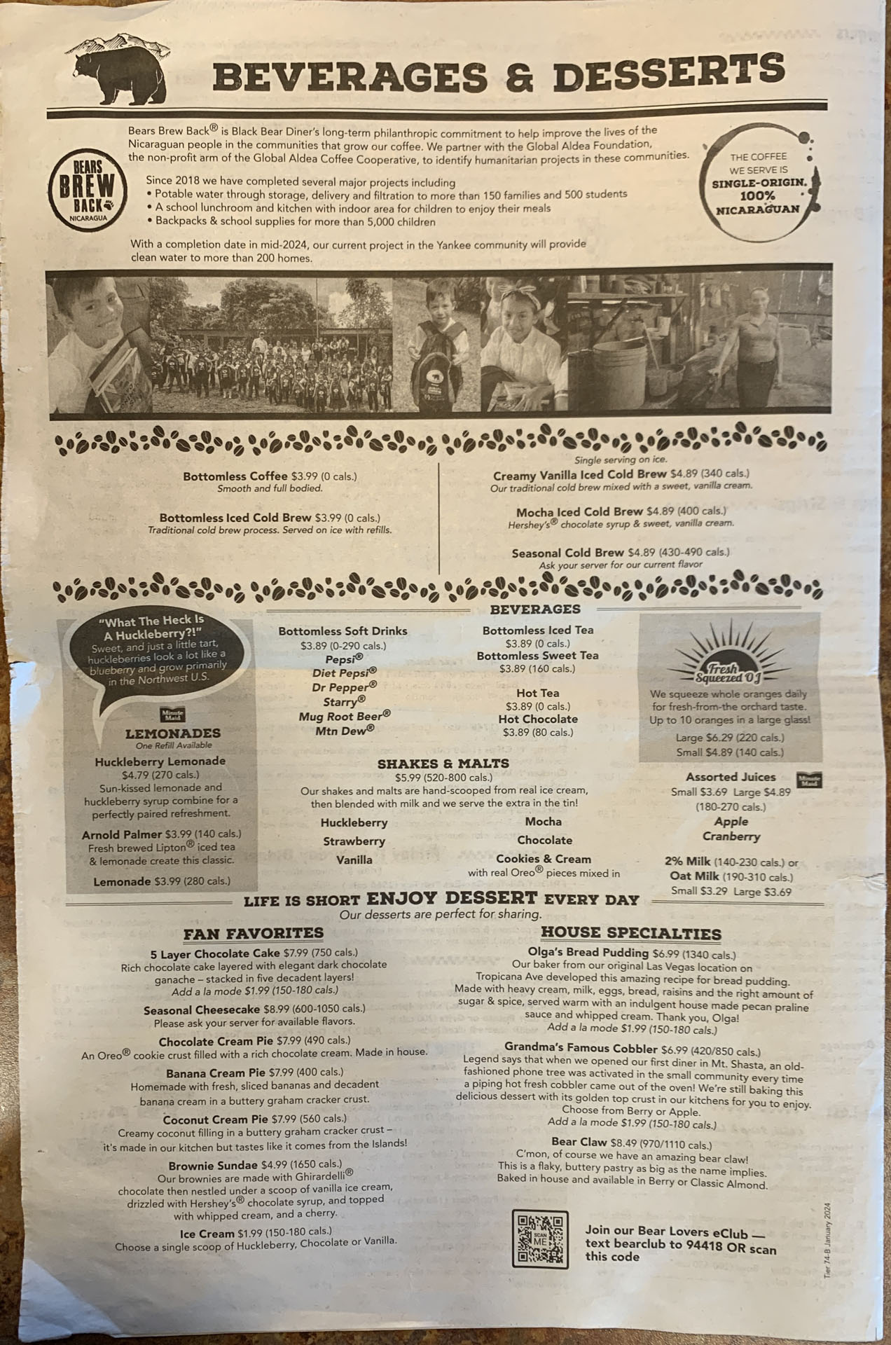 A printed restaurant menu page titled "Beverages & Desserts" features a bear illustration, coffee mug graphics, and sections listing drinks, shakes, lemonades, desserts, and house specialties—capturing the cozy charm of a family restaurant like Black Bear Diner.