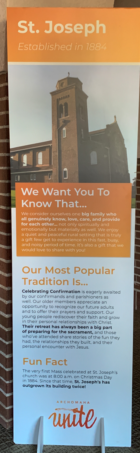 A vertical poster titled "St. Joseph Catholic Church." The text highlights the church's establishment in 1884, its traditions including confirmation ceremonies, and notes it has been rebuilt twice. An image of the church is at the top.