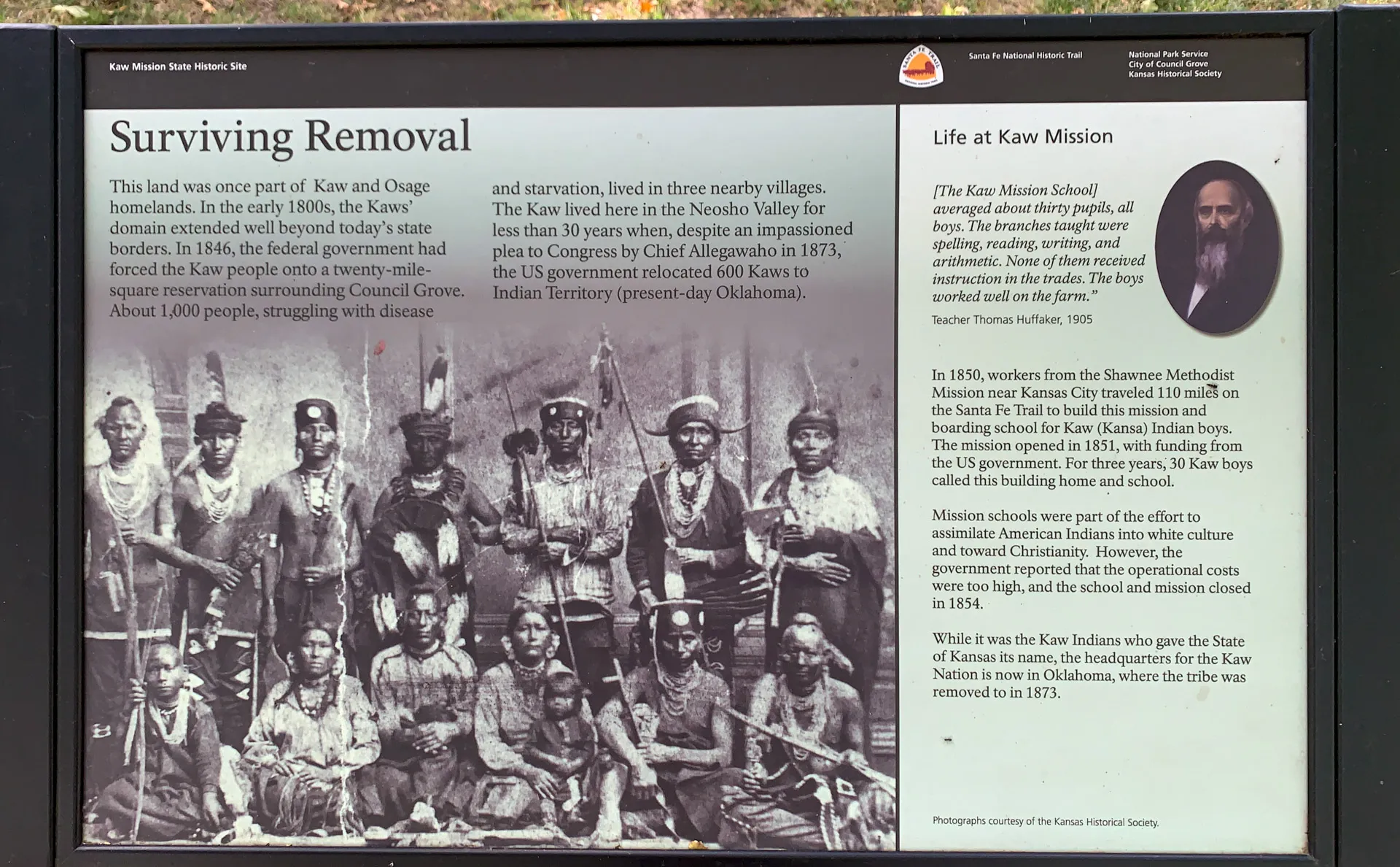 Informational display titled "Surviving Removal" and "Life at Kaw Mission" featuring text about Kaw history, a photo of Kaw individuals in traditional attire from circa 1870, and an image of the Kaw Mission School. A portrait of a man related to the school is included.