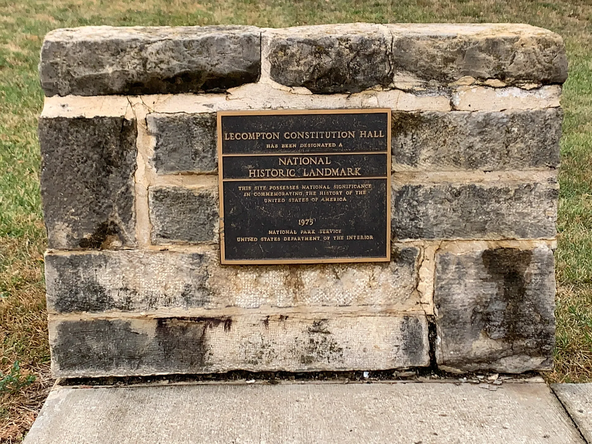 Stone marker for Lecompton Constitution Hall, designated a National Historic Landmark in 1975 by the National Park Service, U.S. Department of the Interior.