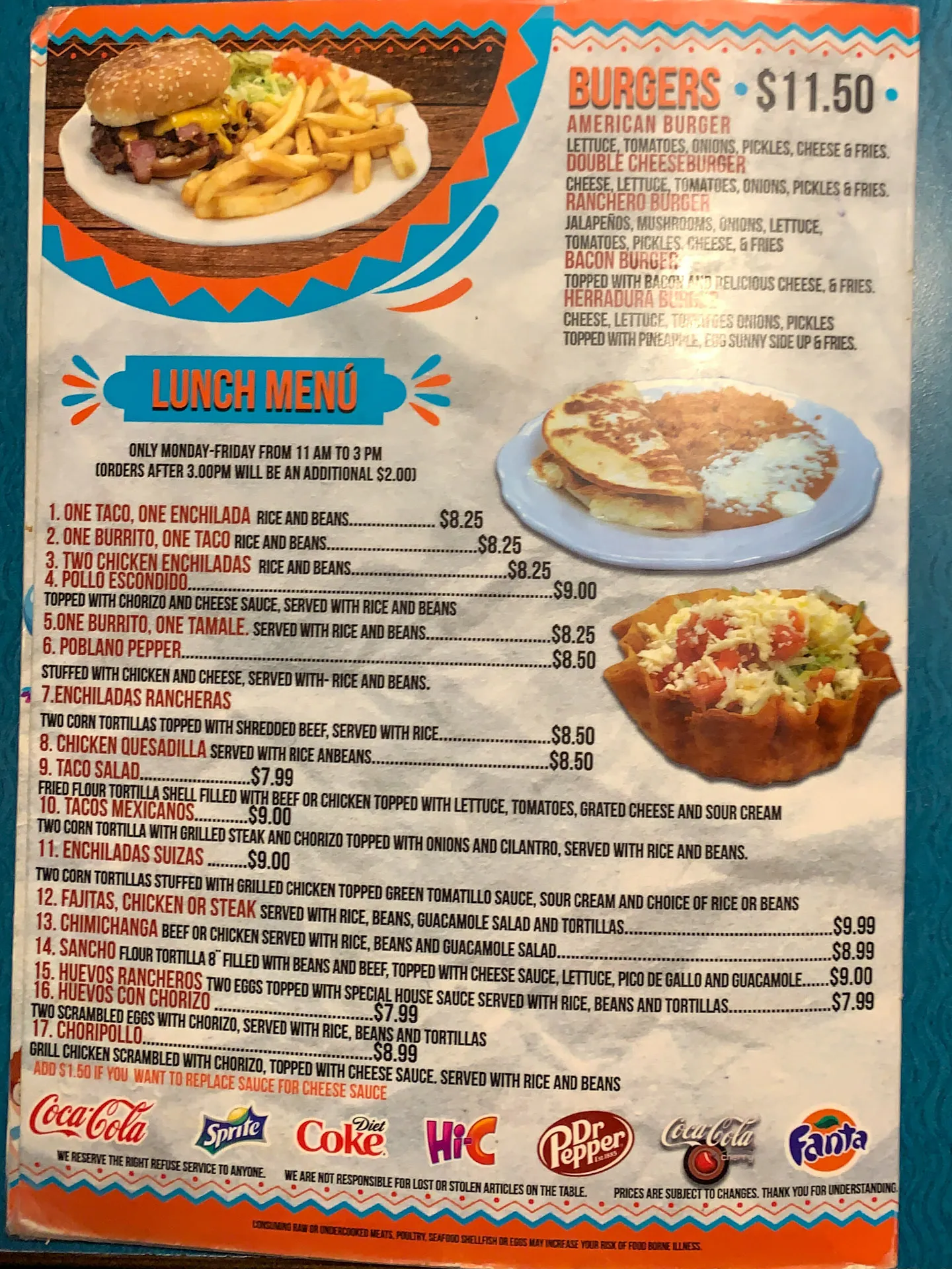 A colorful lunch menu featuring a burger with fries at the top, priced at $11.50. Below, the menu lists various Mexican dishes like tacos, enchiladas, burritos, and fajitas with prices ranging from $7.25 to $10.25. Beverage logos like Coca-Cola, Sprite, and Dr Pepper line the bottom.