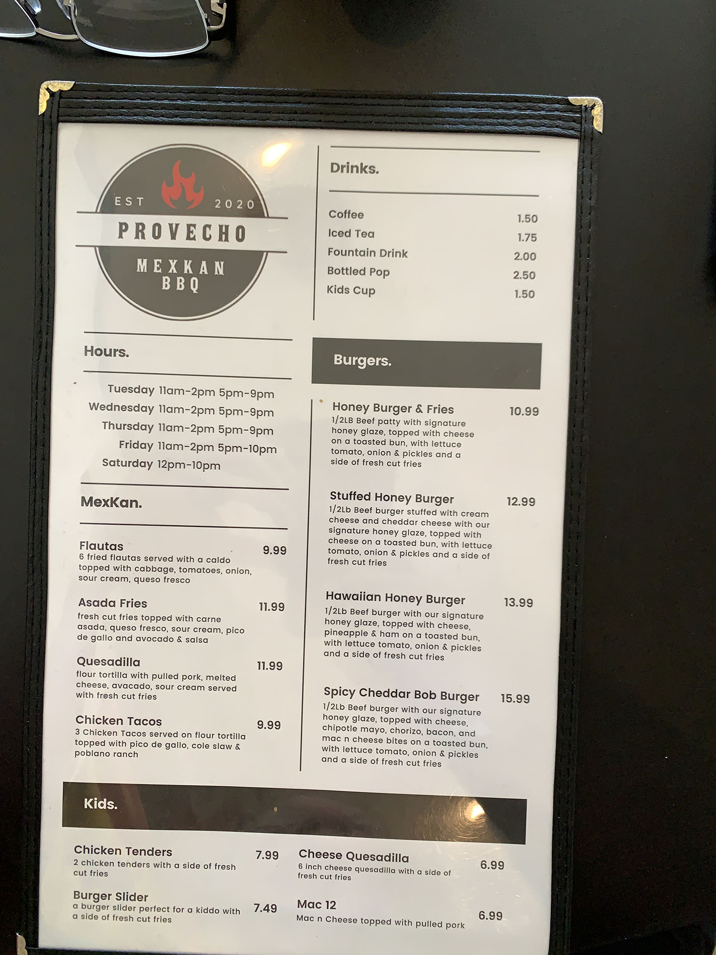 Menu of Provecho Mexxan BBQ featuring hours of operation, various drink options, Mexxan dishes like spicy chicken tacos and chicken tostadas, a range of burgers, and kids’ meals including chicken tenders and quesadillas.
