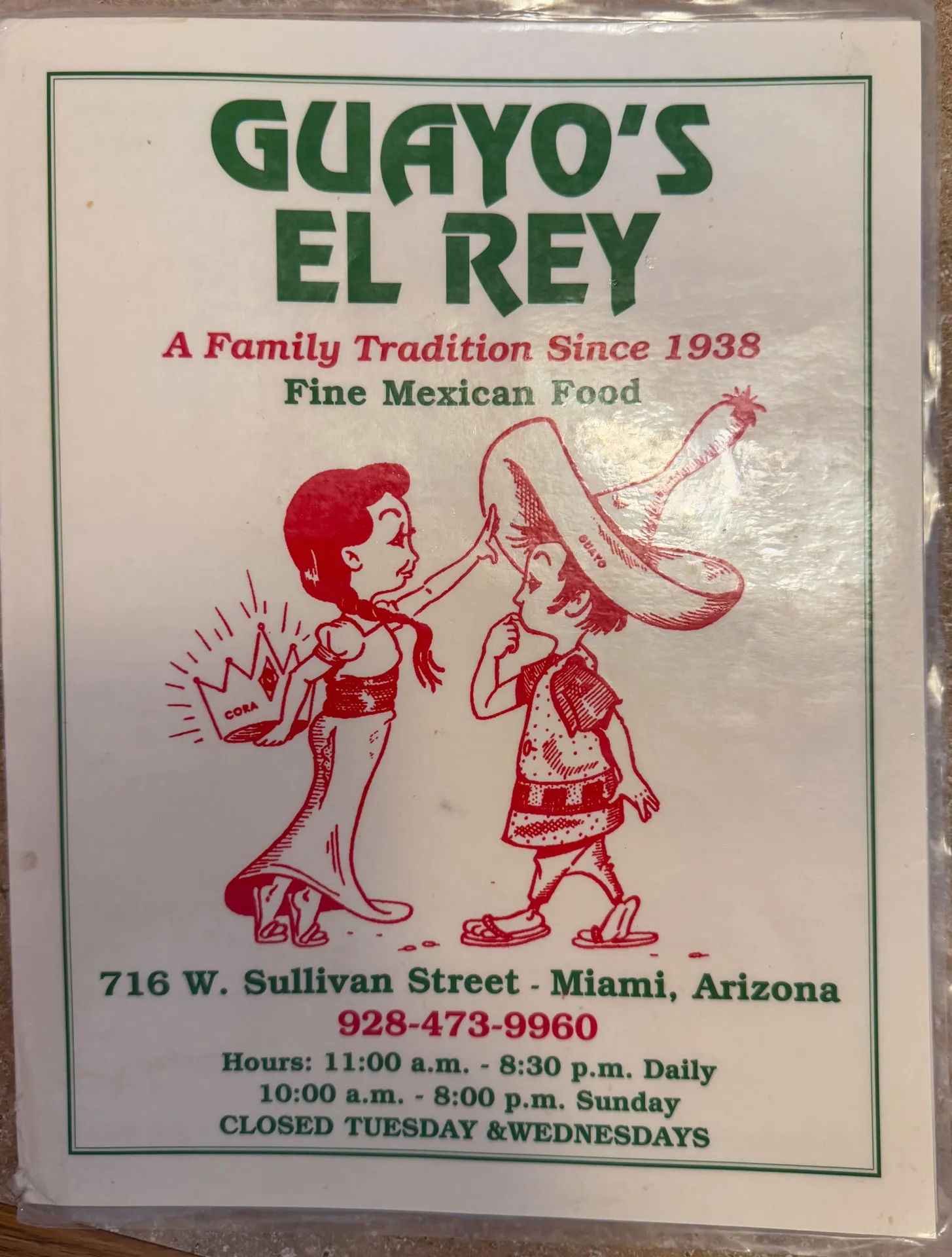 Illustrated menu cover for "Guayo's El Rey" featuring a cartoon girl placing a large sombrero on a boy. Text above reads "A Family Tradition Since 1938, Fine Mexican Food." Address: 716 W. Sullivan Street, Miami, Arizona, with phone number and hours. Closed Tuesdays and Wednesdays.